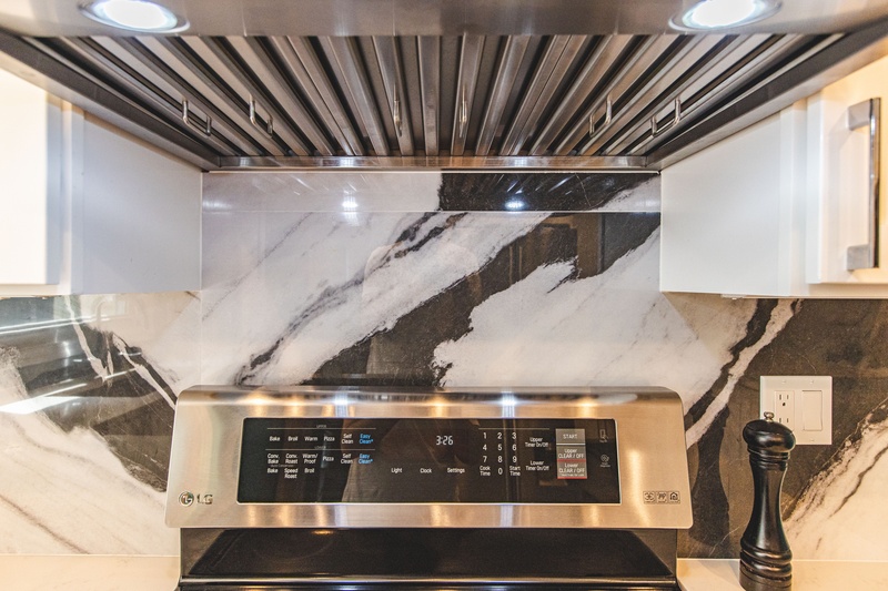 Kitchen range with detailed hood and backsplash